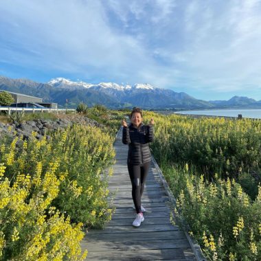 Caregiver burnout / Amyloidosis News Today / Image of the author walking outside near the water with mountains in the background.