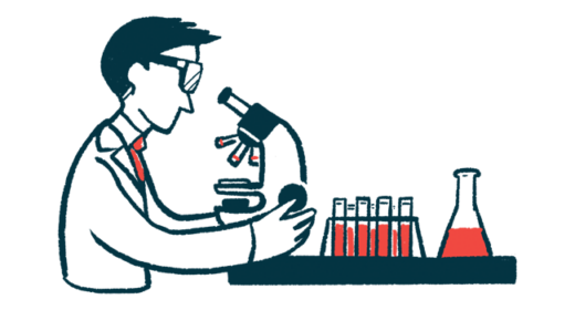 A researcher uses a microscope in a lab.