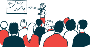 A speaker uses a graph to share data in a conference presentation.