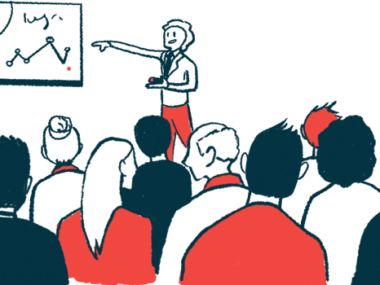 A speaker uses a graph to share data in a conference presentation.