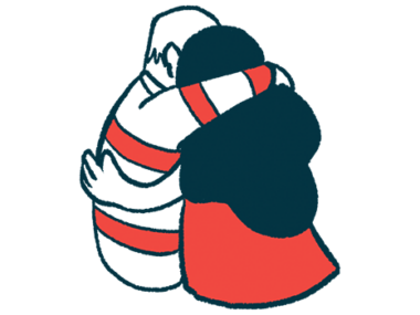 Two people embrace in a side hug.