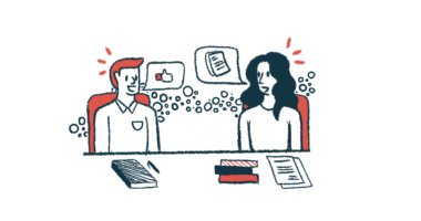 Two people sit at a table sharing ideas.