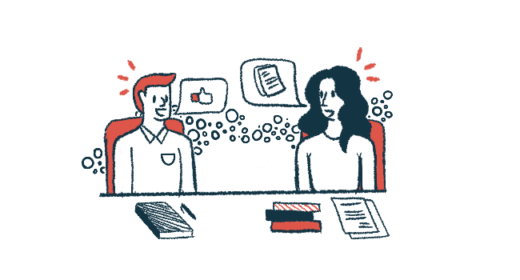 Two people sit at a table sharing ideas.