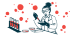 A scientist works with blood and petri dishes in a lab.